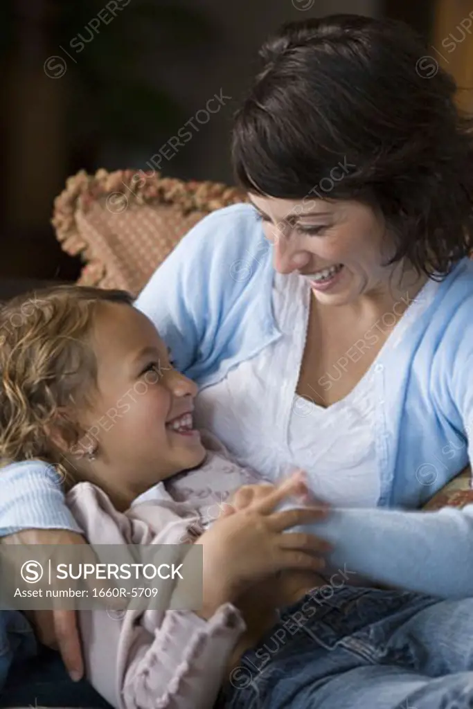 Close-up of a mother tickling her daughter