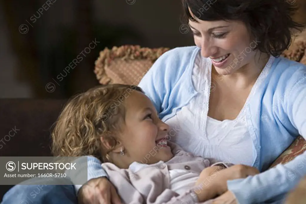 Close-up of a daughter lying on her mother's lap