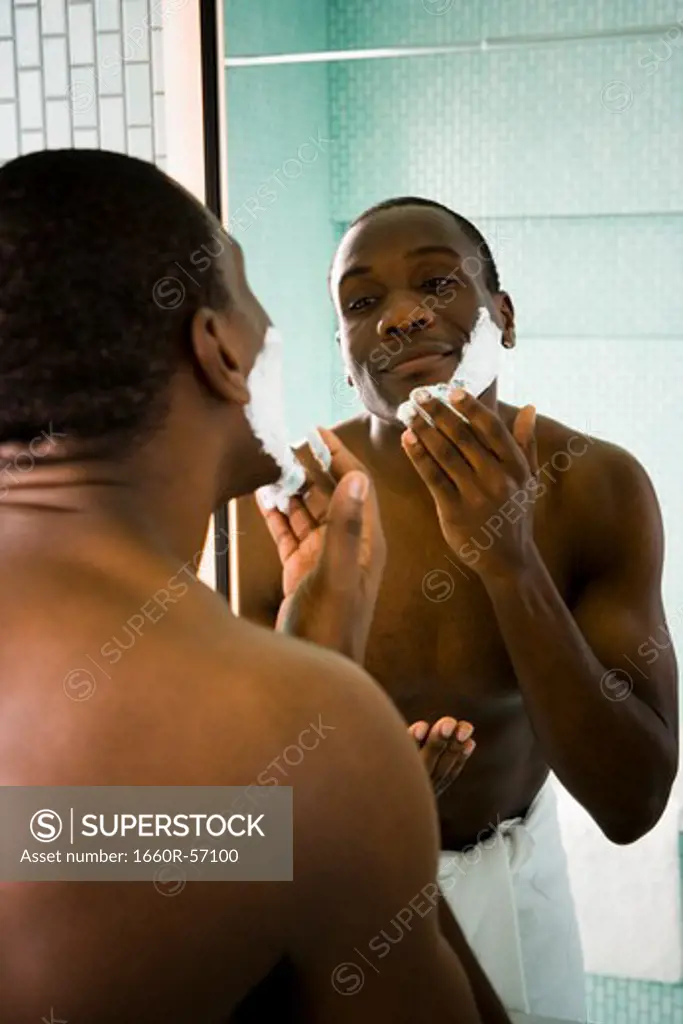 Male putting shaving cream on face