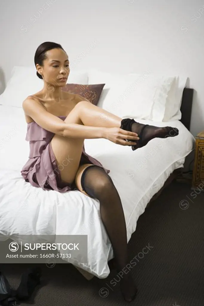 Woman putting on pantyhose