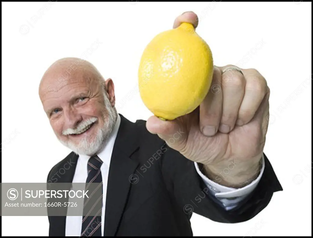 Portrait of a businessman showing a lemon