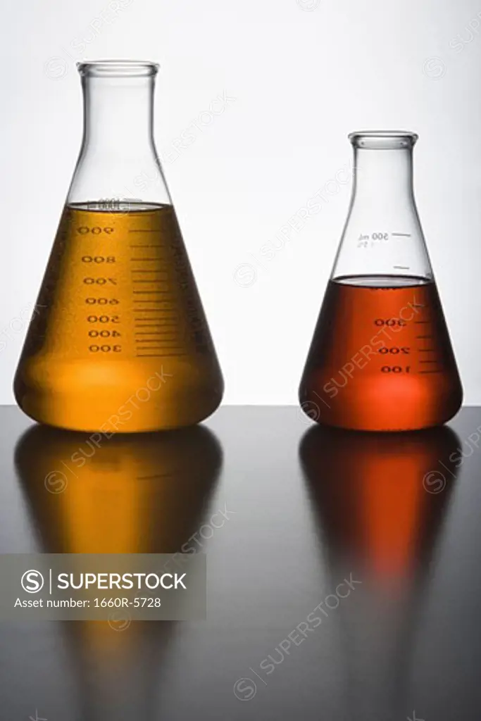 Close-up of two liquid filled flasks