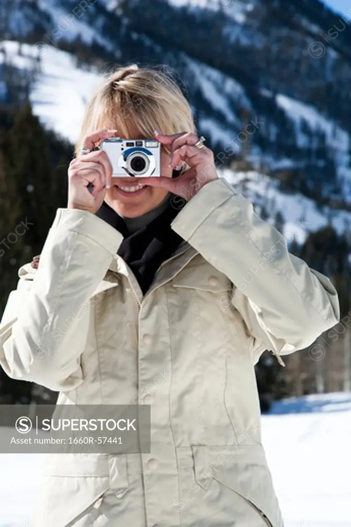 Woman using a camera outside