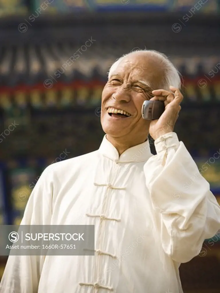 Man talking on cell phone outdoors smiling