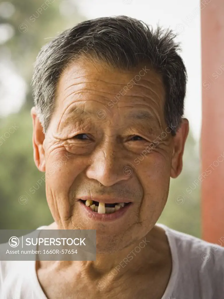 Portrait of a toothless man outdoors smiling