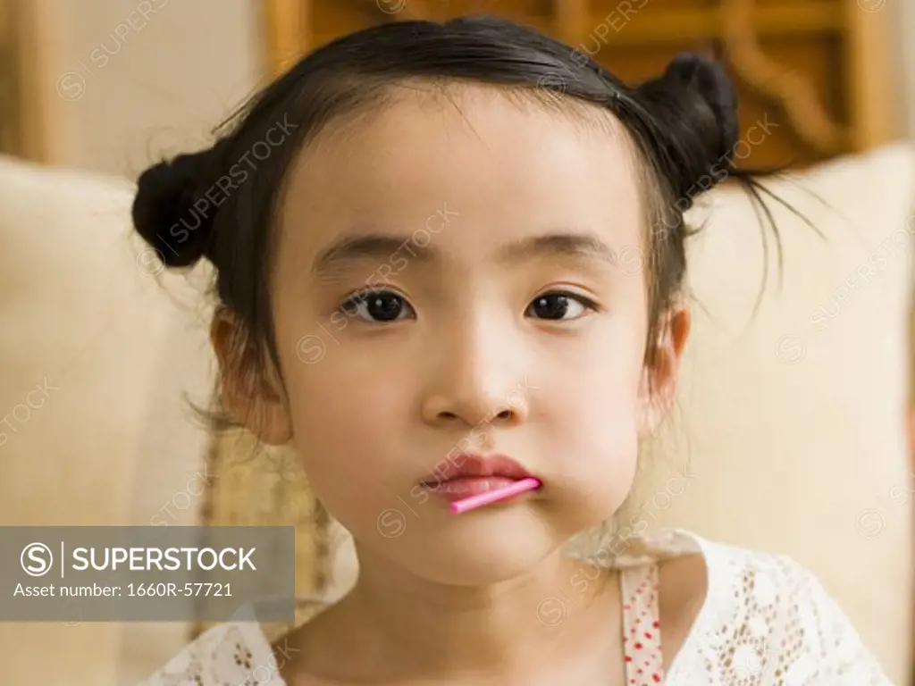 Closeup of girl with lollipop in mouth