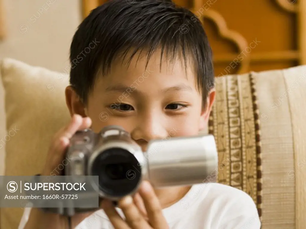 Closeup of boy with video camera