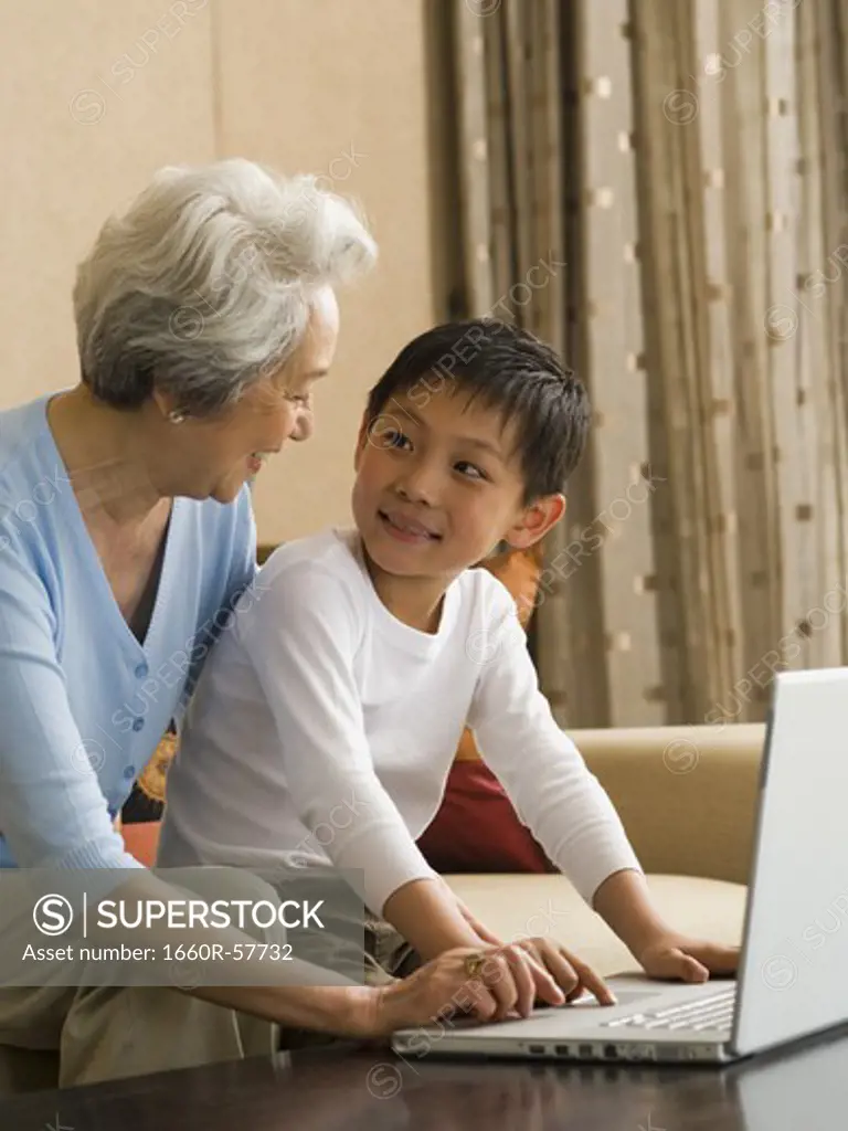 Grandmother and grandson with laptop