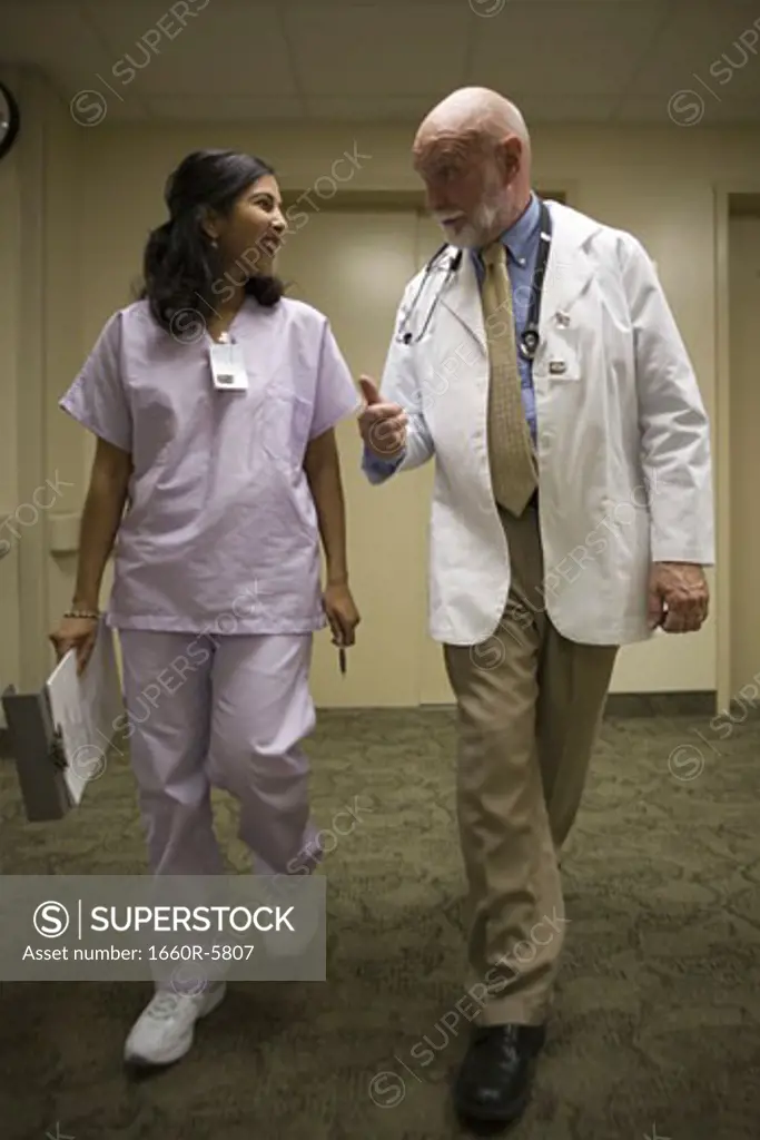 Male doctor talking to a female nurse