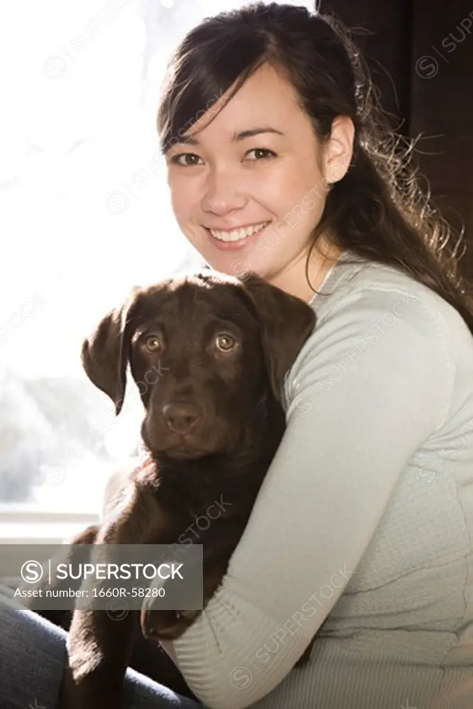 young woman with a brown puppy