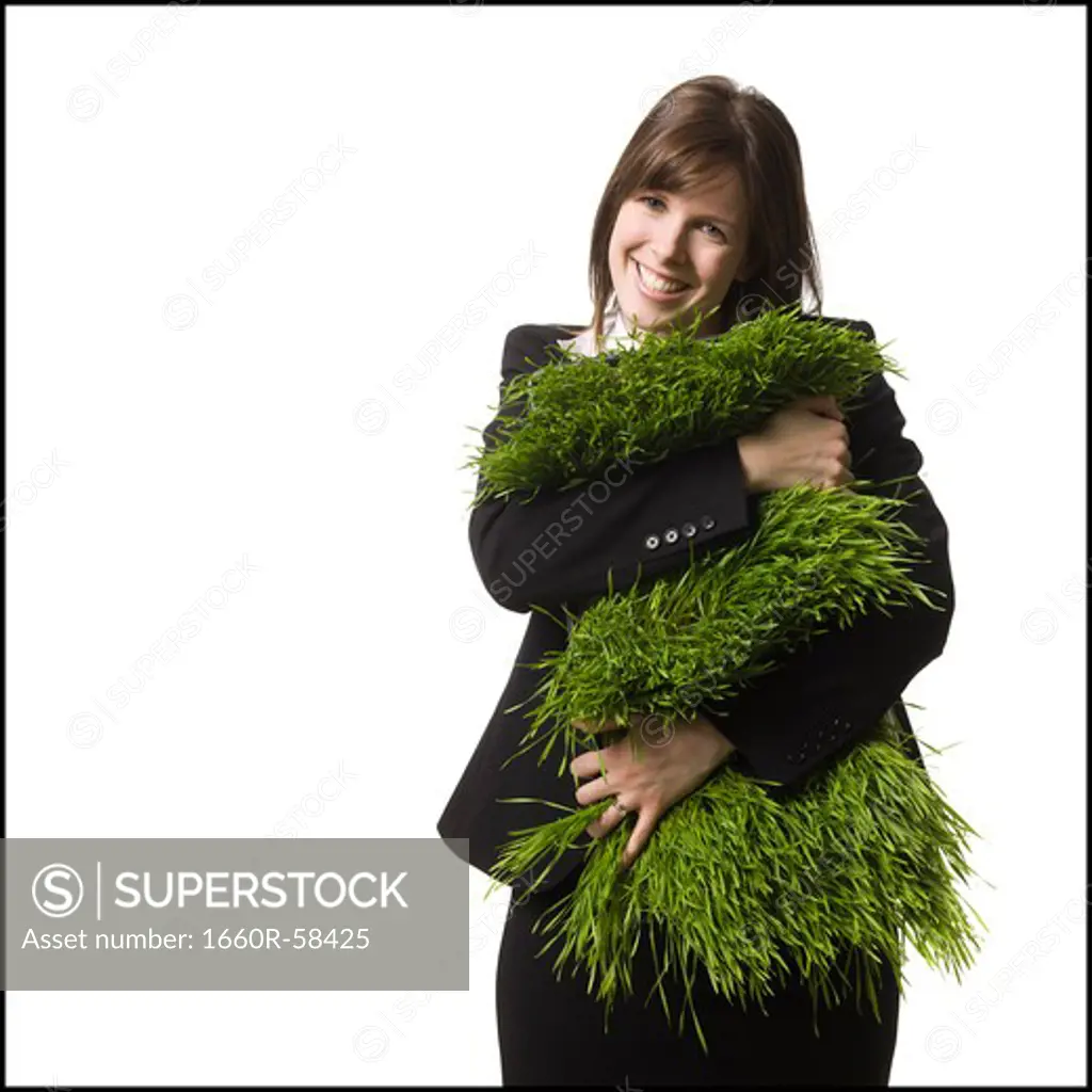 businessperson holding a patch of grass