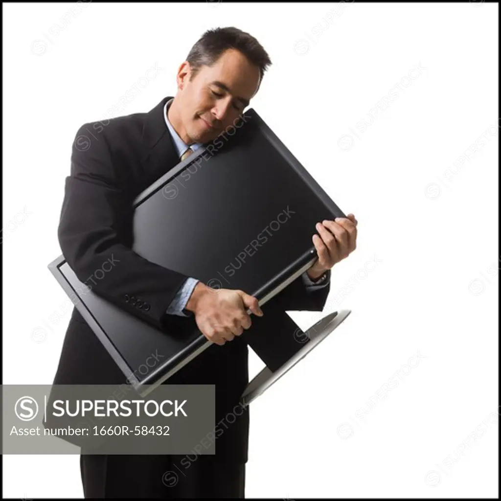 businessman holding a flat screen monitor