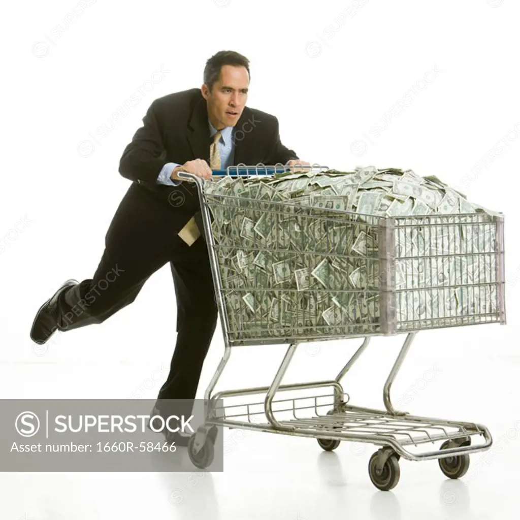 businessperson with a shopping cart full of money