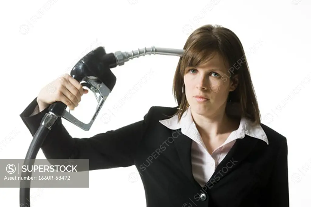 woman holding a gas pump to her head