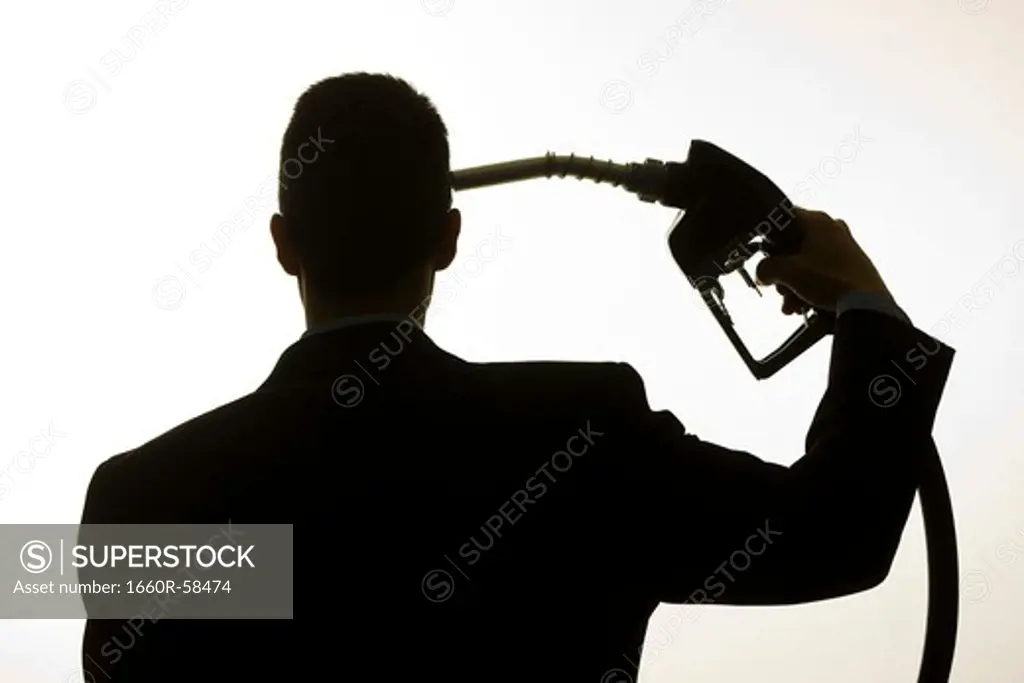 man holding a gas pump to his head