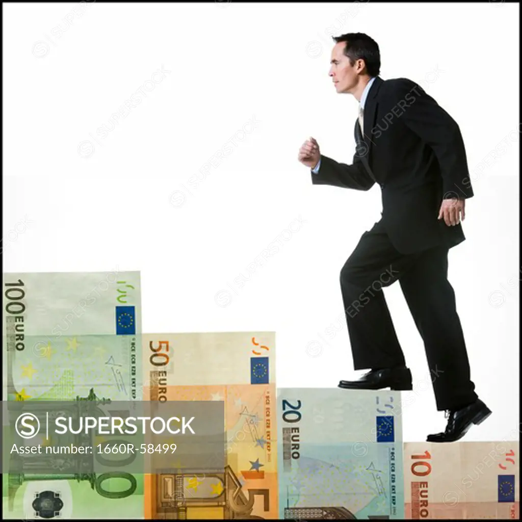 businessperson climbing a staircase of money