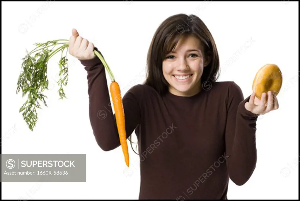 young woman choosing between a carrot and a donut