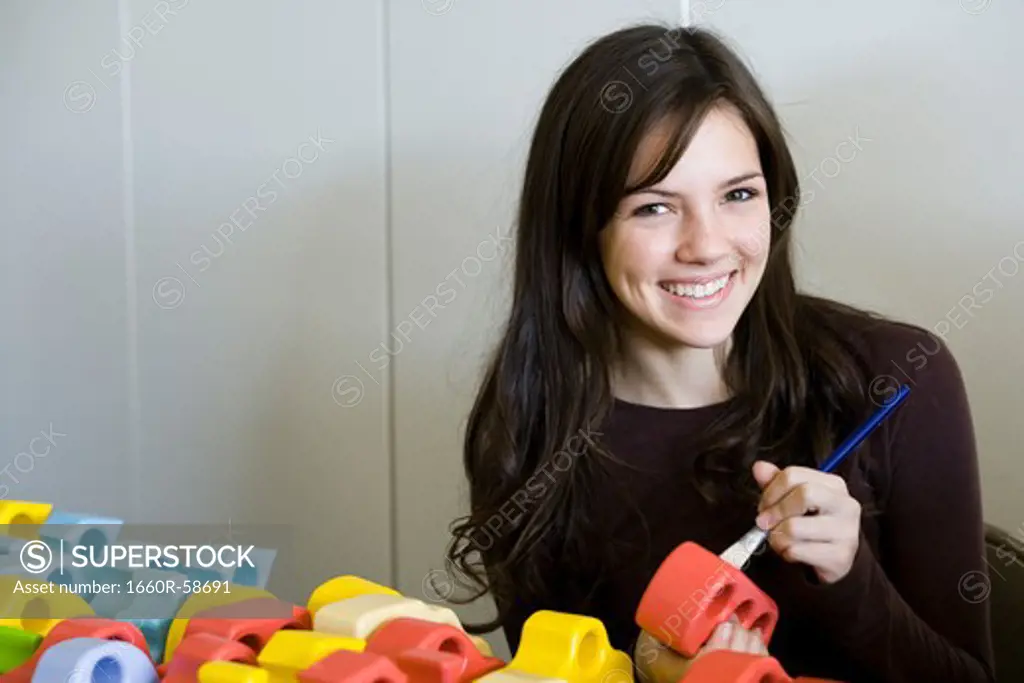 girl painting toys