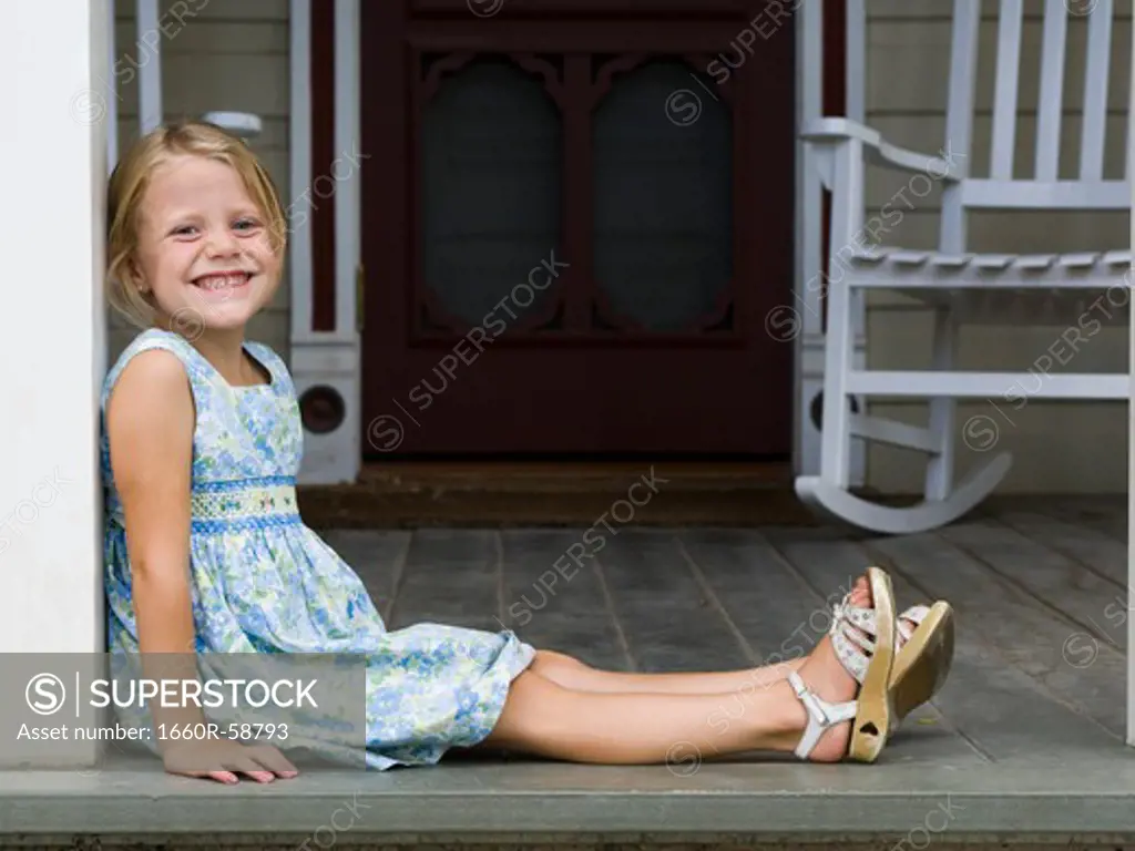 girl sitting on the front porch