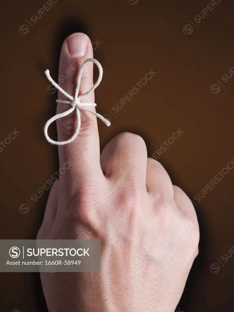 Finger with piece of string tied around it