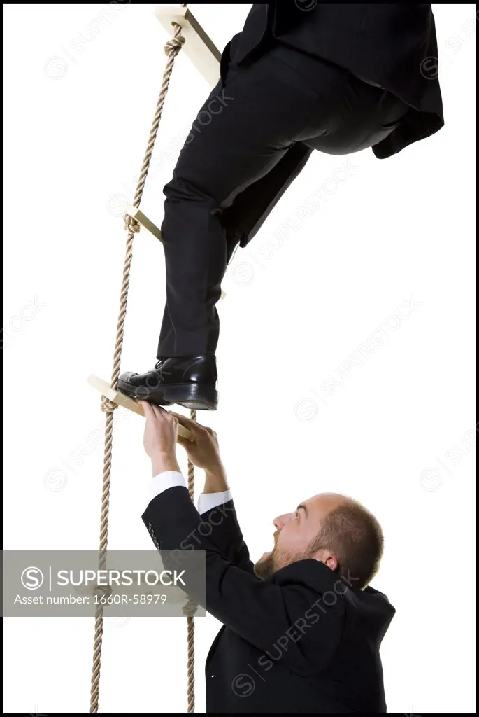 Two men climbing a ladder