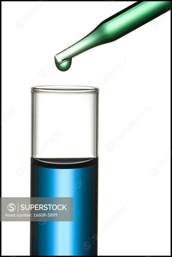 Close-up of a dropper over a test tube