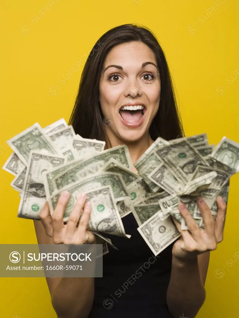 Happy woman holding US dollar bills