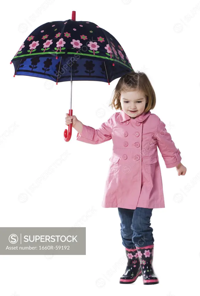Studio portrait of girl (2-3 years) holding umbrella