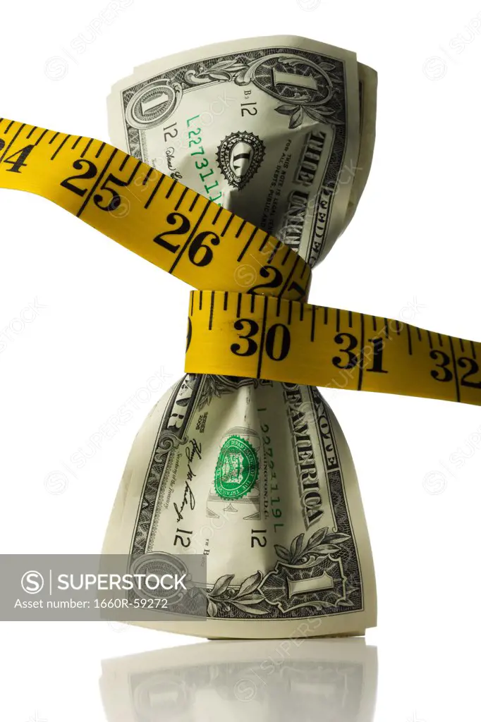 One dollar banknotes tied up with measuring tape against white background