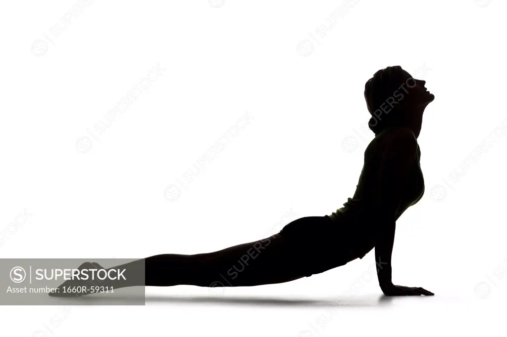 USA, Utah, Orem, Silhouette of woman in cobra pose against white background