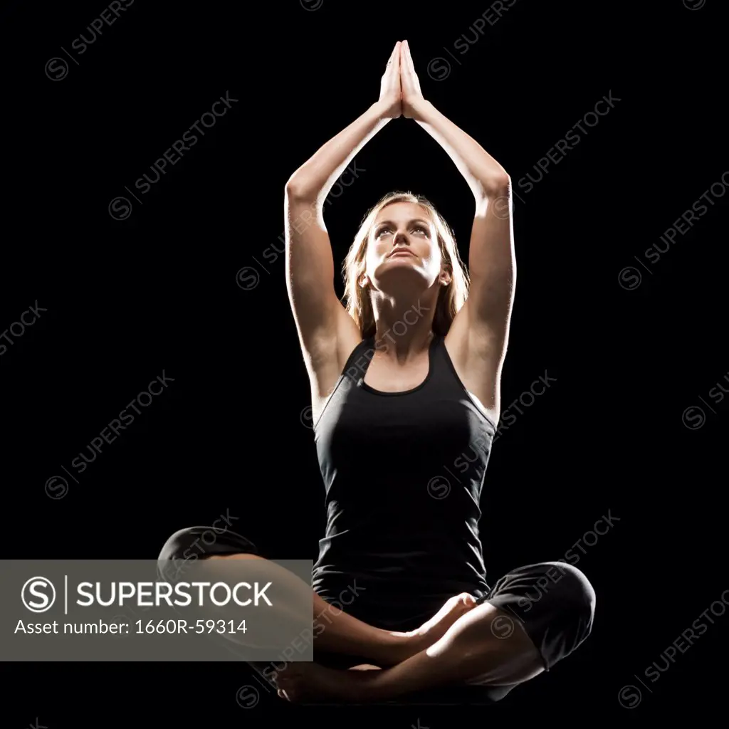 Young woman doing yoga, studio shot
