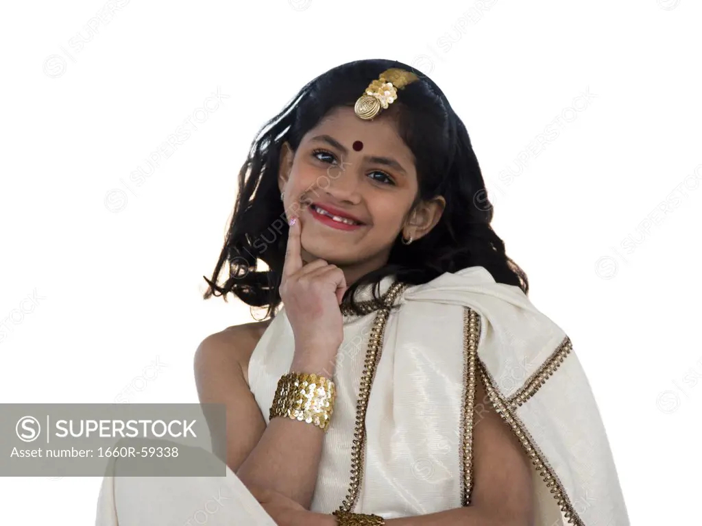 Girl (8-9) wearing traditional sari, smiling, portrait, studio-shot