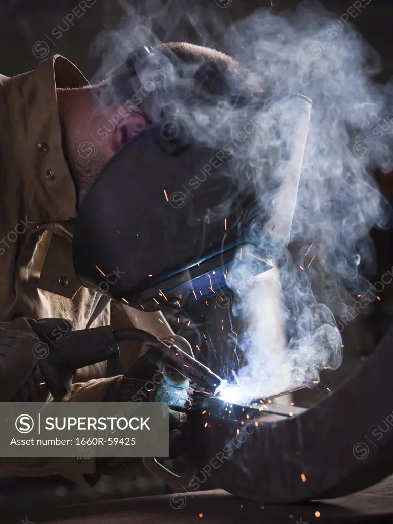 USA, Utah, Orem, man welding metal