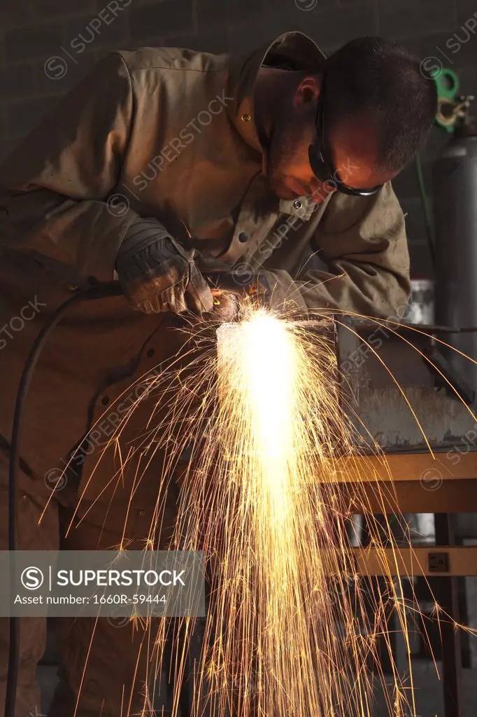 USA, Utah, Orem, man welding metal in workshop
