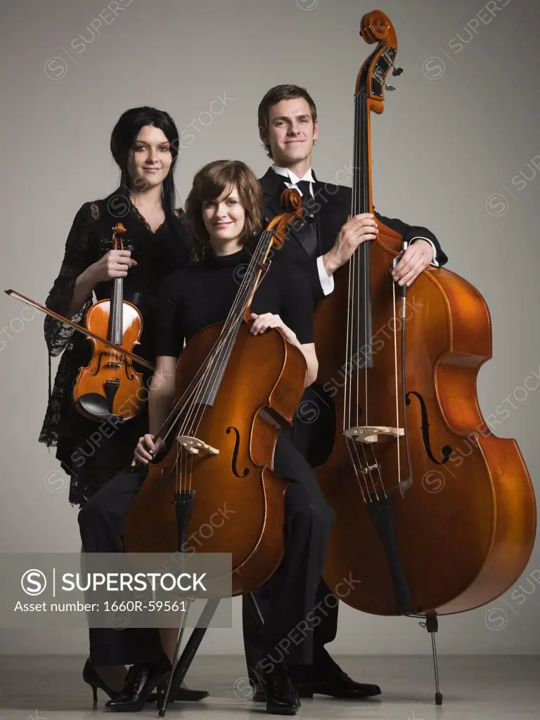 Studio portrait of three young musicians with instruments