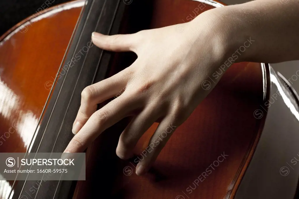 Close-up of young woman playing cello