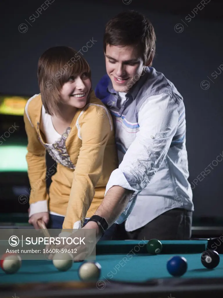 USA, Utah, American Fork, young couple playing pool