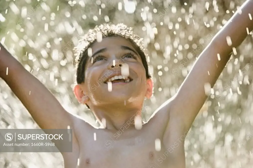 Close-up of a boy in a sprinkler