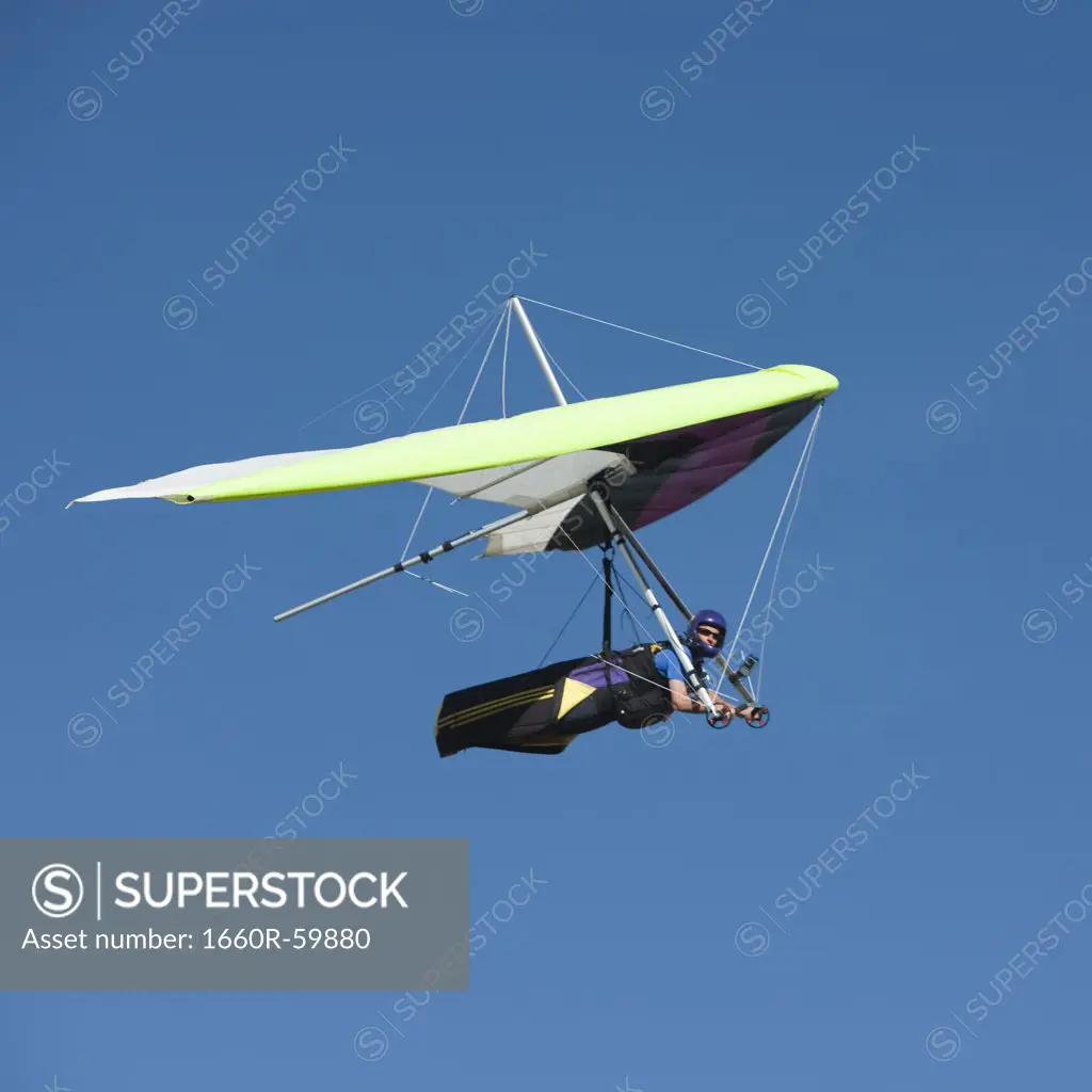 USA, Utah, Lehi, mid adult man hang gliding, low angle view