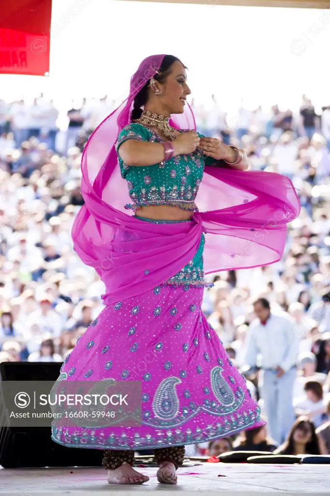 USA, Utah, Spanish Fork, mid adult dancer in traditional clothing performing on stage