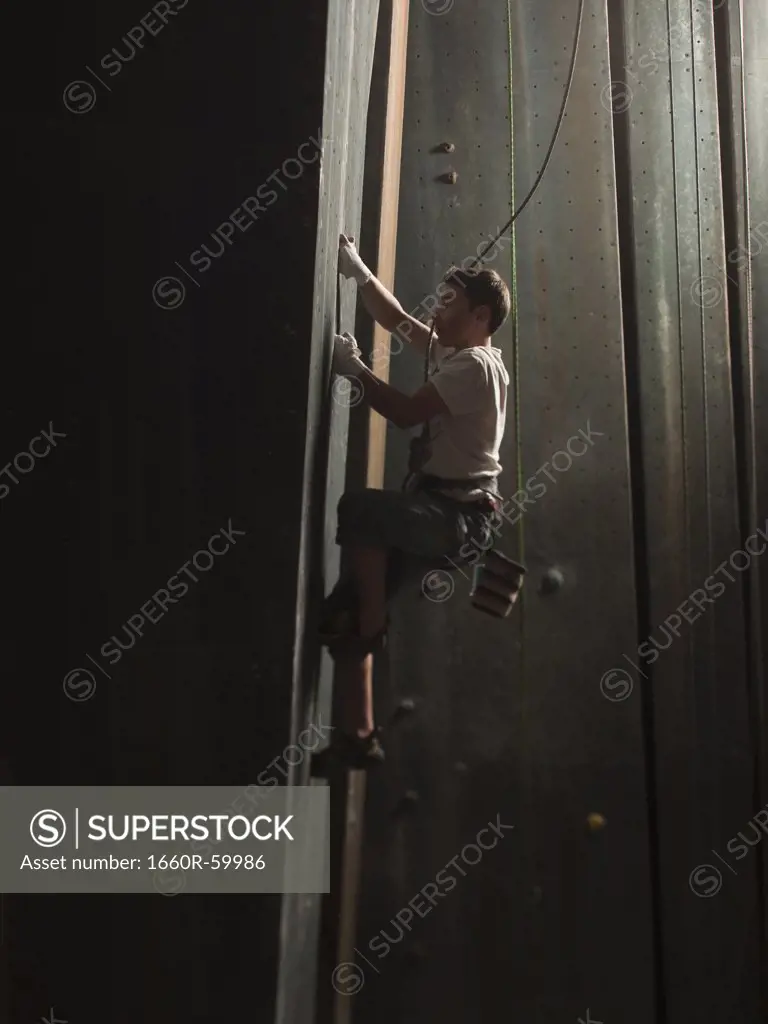 USA, Utah, Sandy, boy climbing in indoor climbing gym, side view