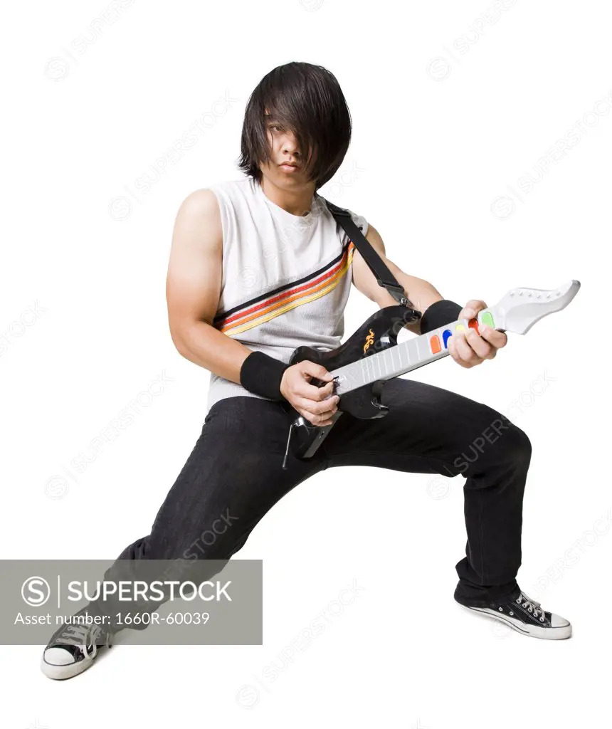 Young man playing guitar video game, portrait