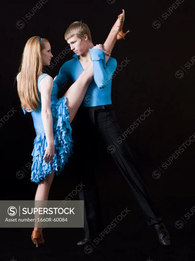 Young woman posing with teenage boy (16-17) as two professional dancers, studio shot