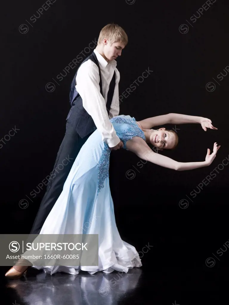 Young woman posing with teenage boy (16-17) as two professional dancers, studio shot