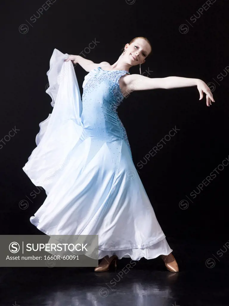Young woman posing as professional dancer, studio shot