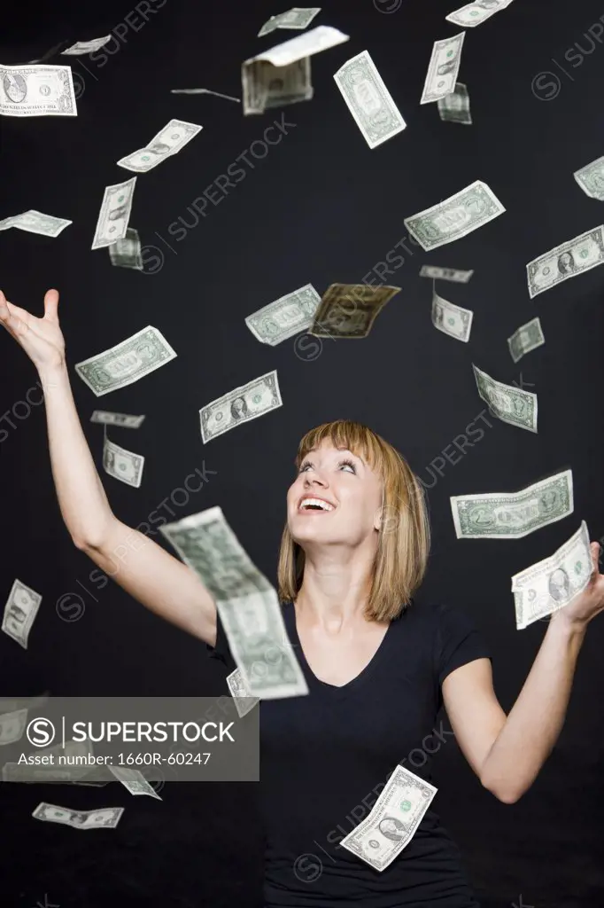Portrait of young woman playing with banknotes, digital enhancement