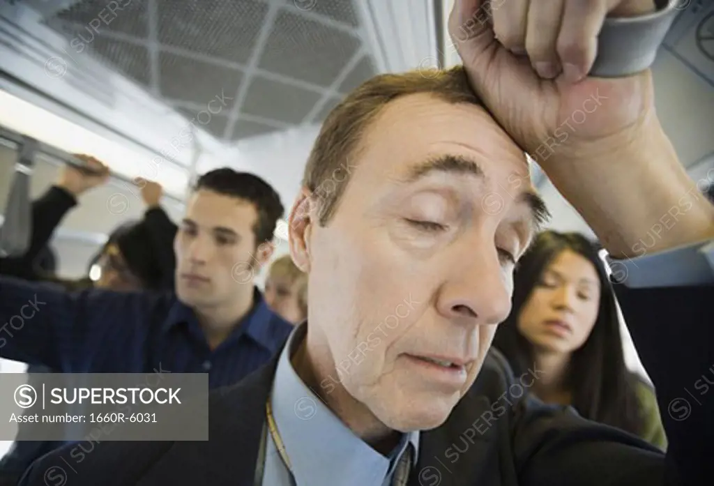 Close-up of a mature man traveling in a passenger train