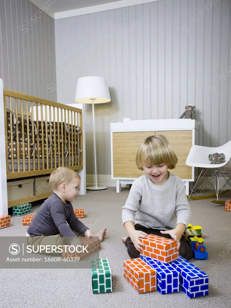 USA, Utah, Provo, Two boys (18-23 months,2-3) playing with building blocks