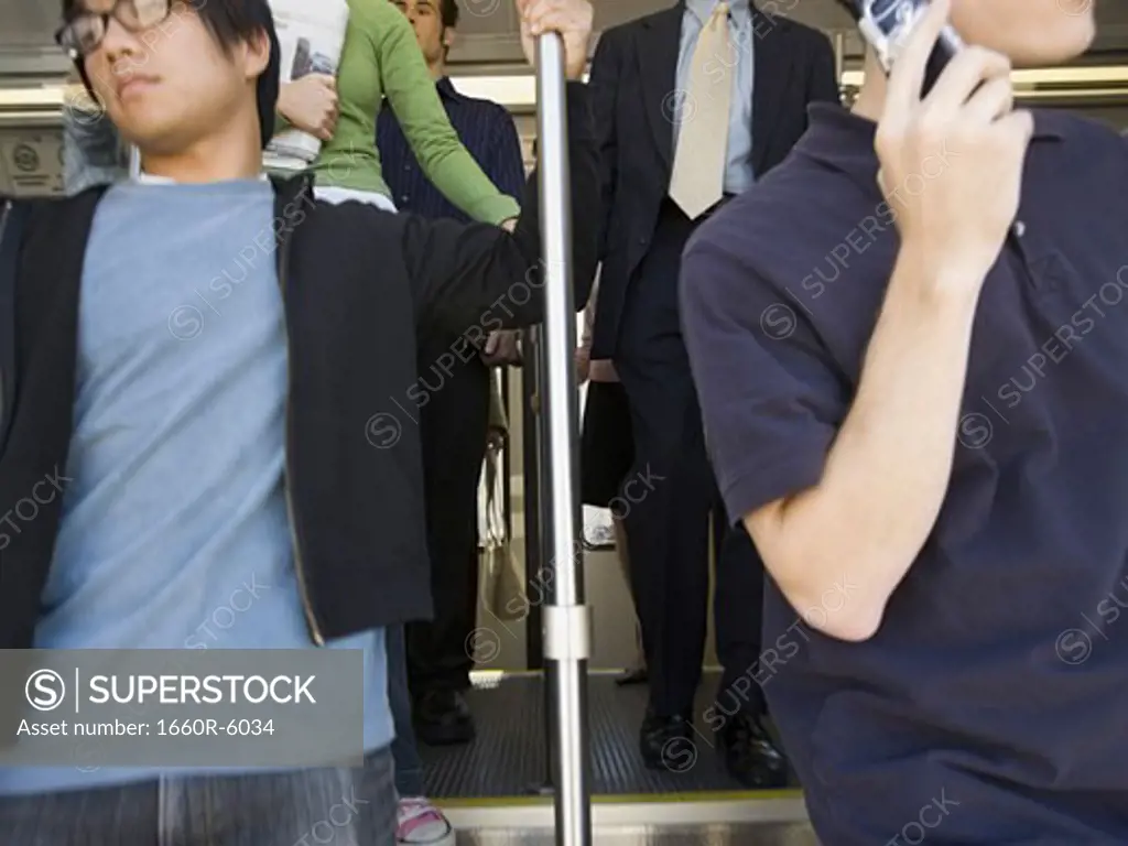 Five people exiting  a commuter train