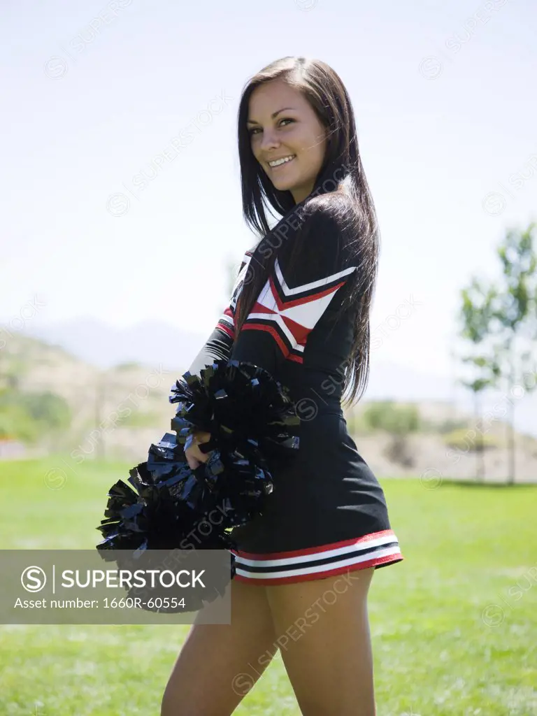 USA, Utah, American Fork, Portrait of smiling cheerleader holding pom-pom